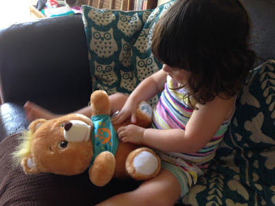 girl playing with Freddy bear