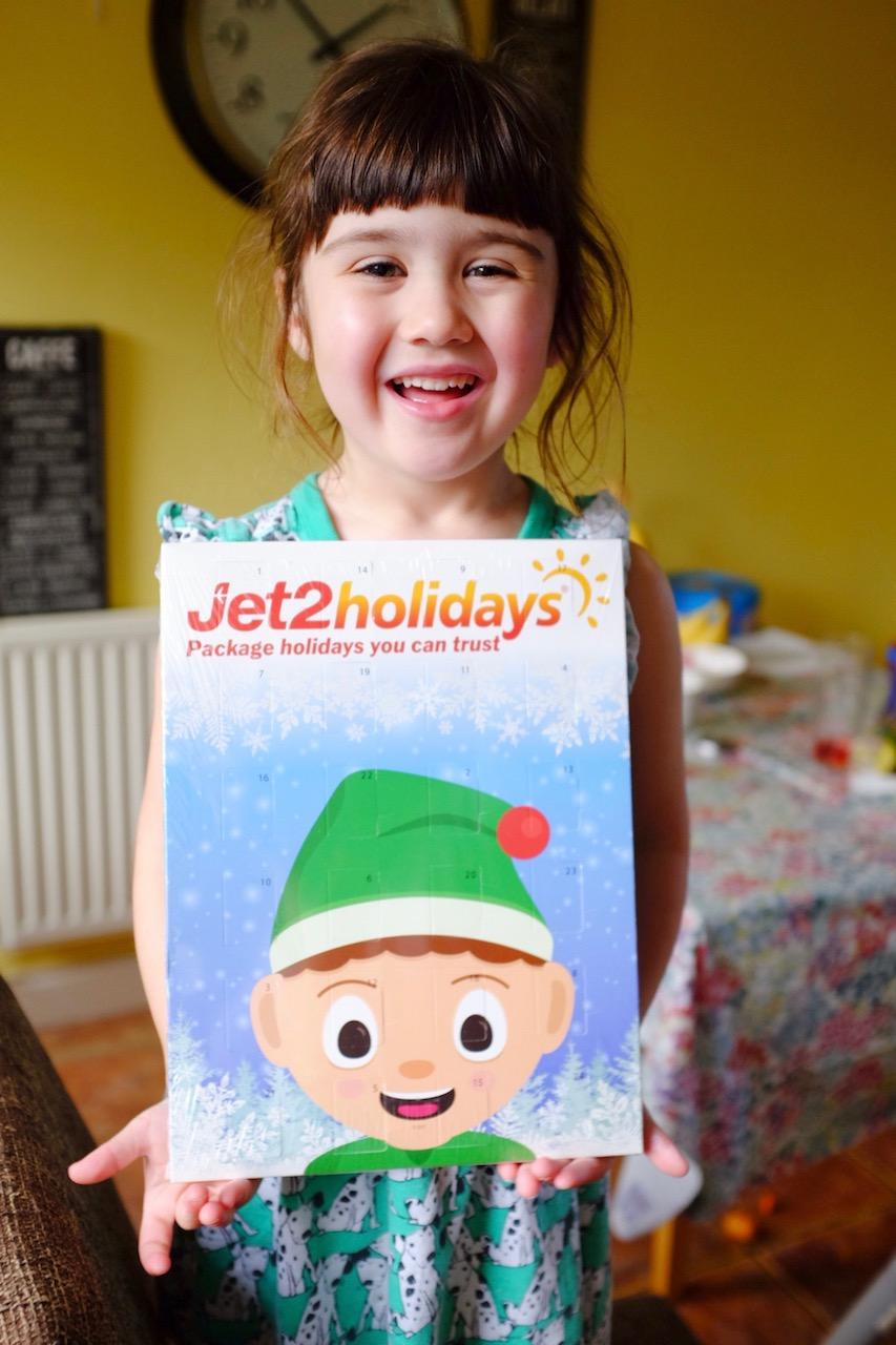 girl holding a jet2 holidays advent calendar