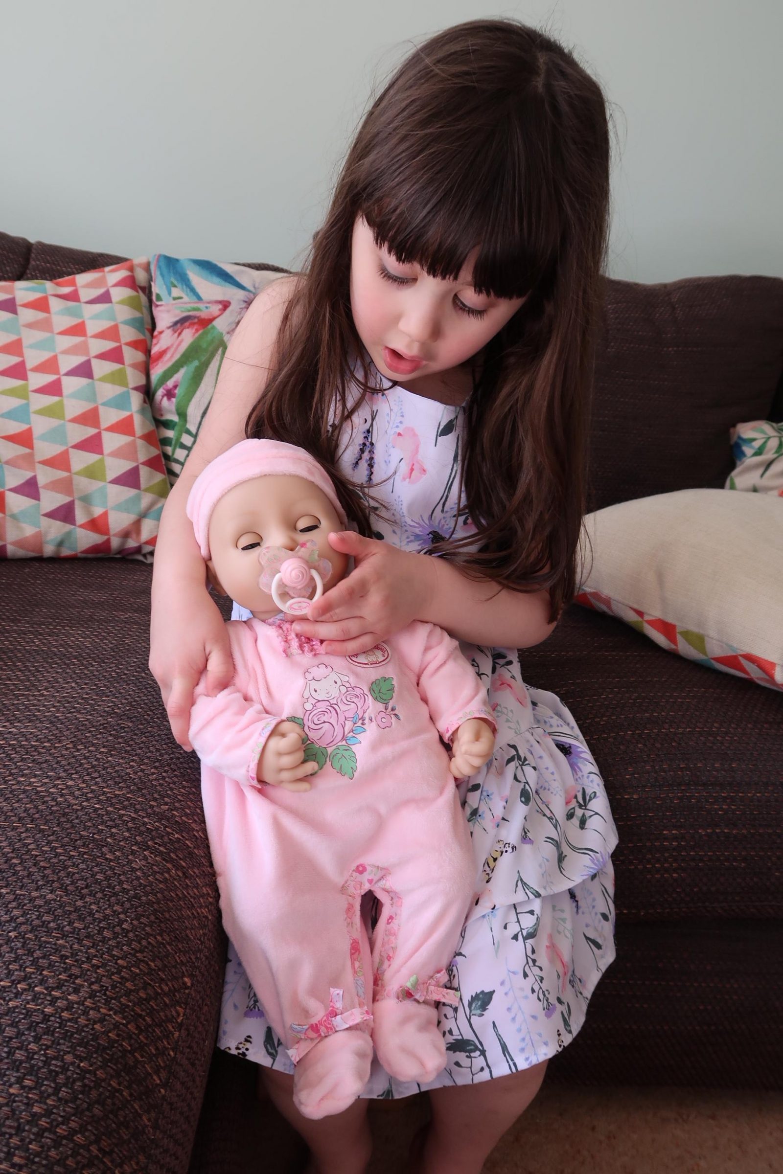 girl holding interactive baby Annabell doll