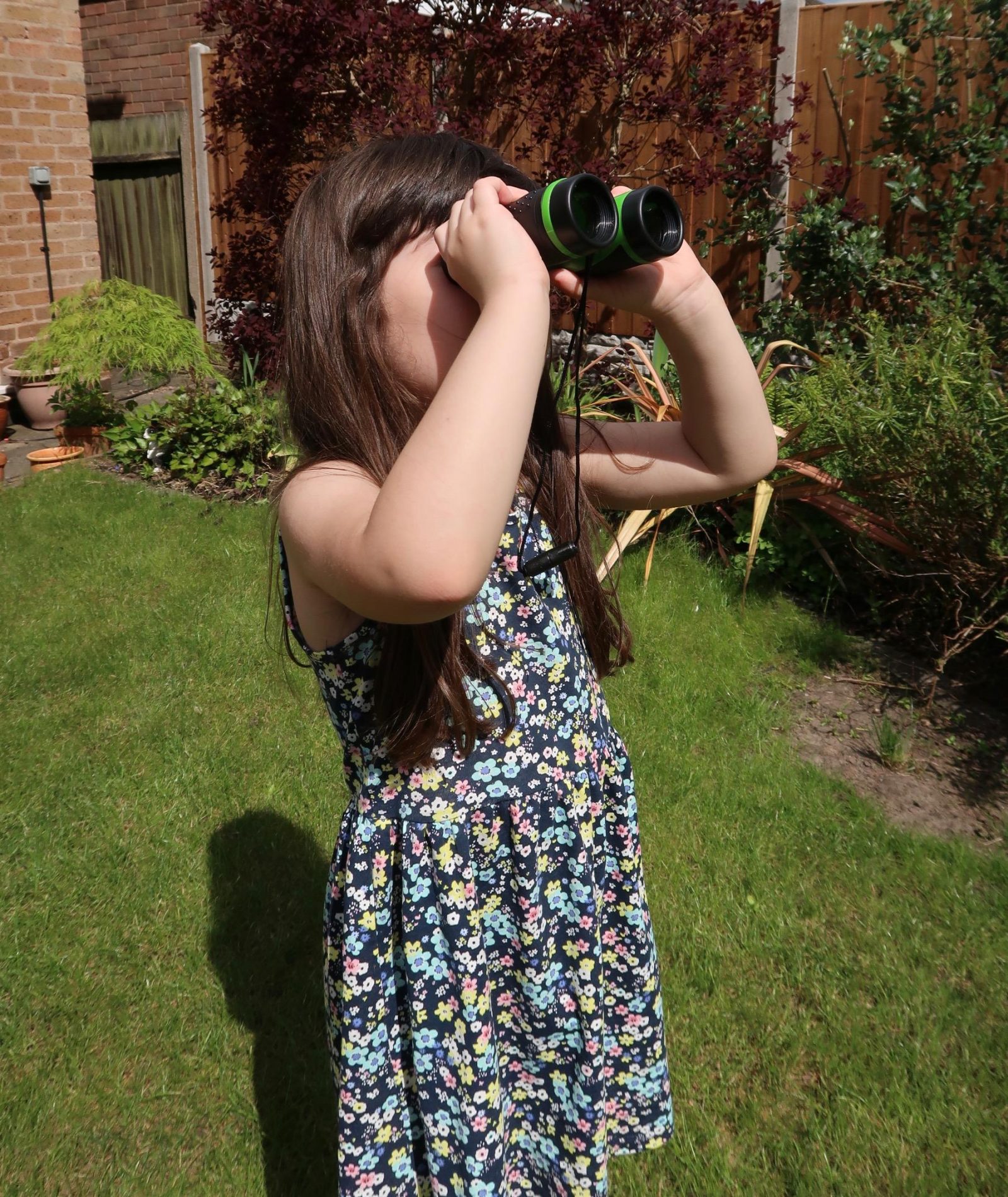 girl playing with binoculars outdoor adventures