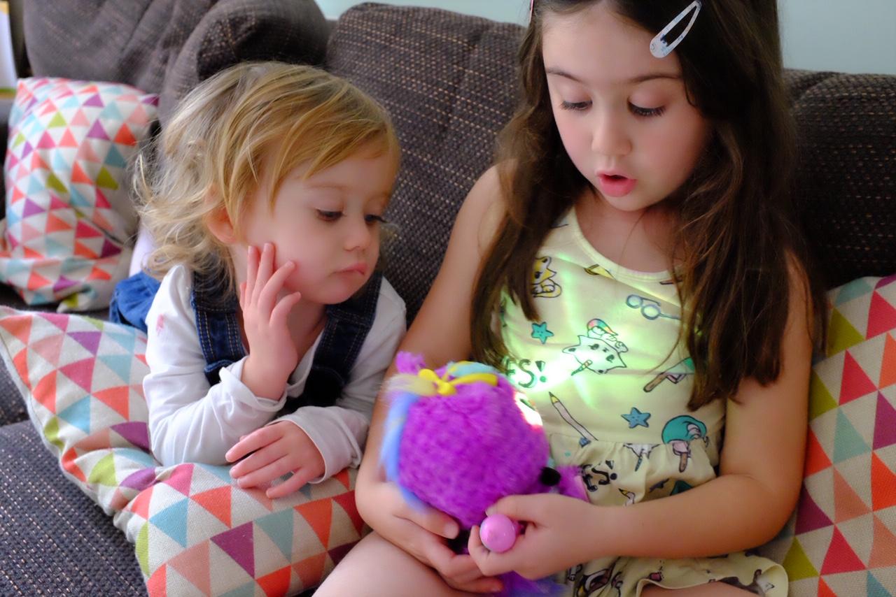 sister looking at the Hatchimals HatchiBabies