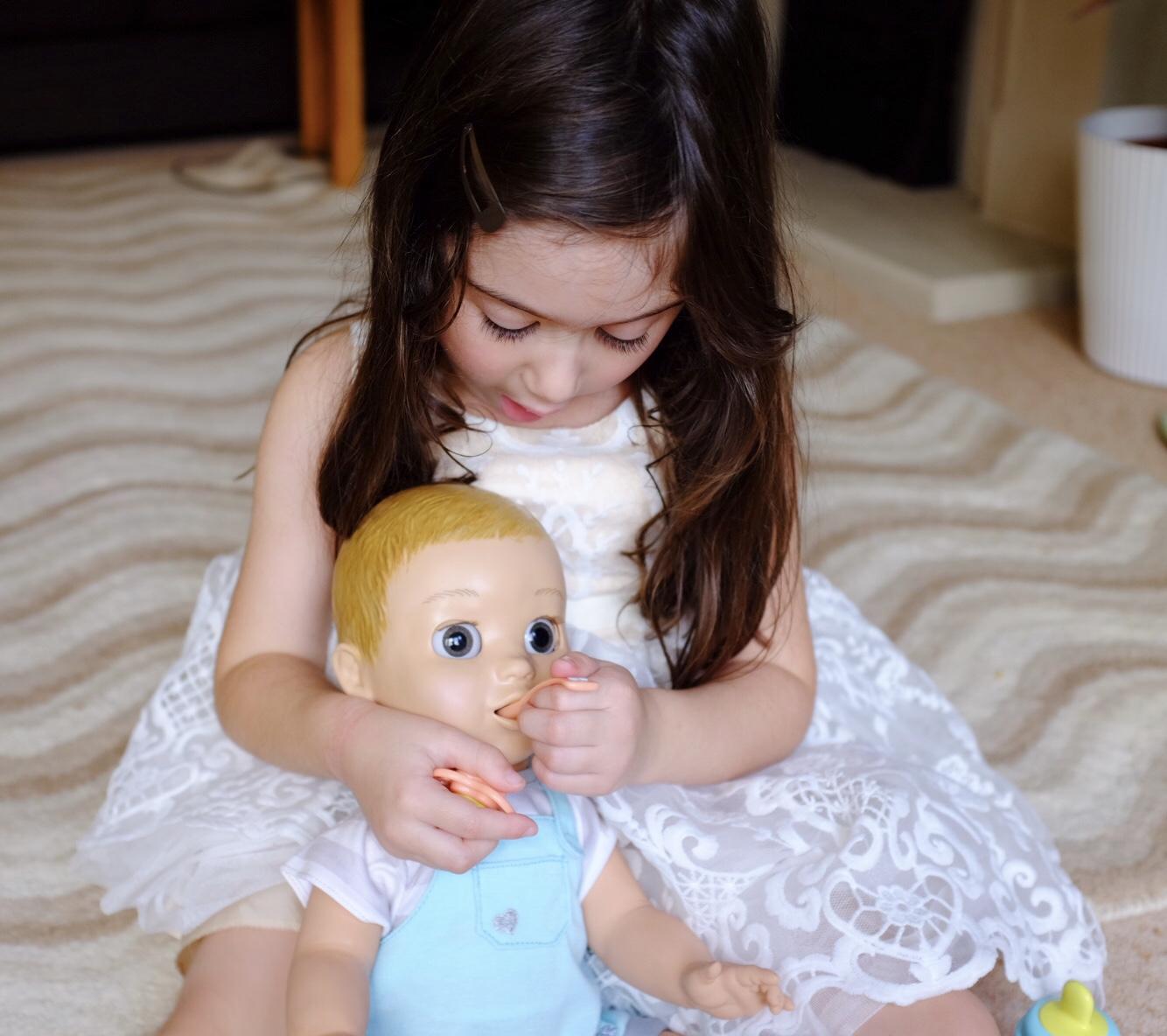 Girl feeding Luvabeau doll