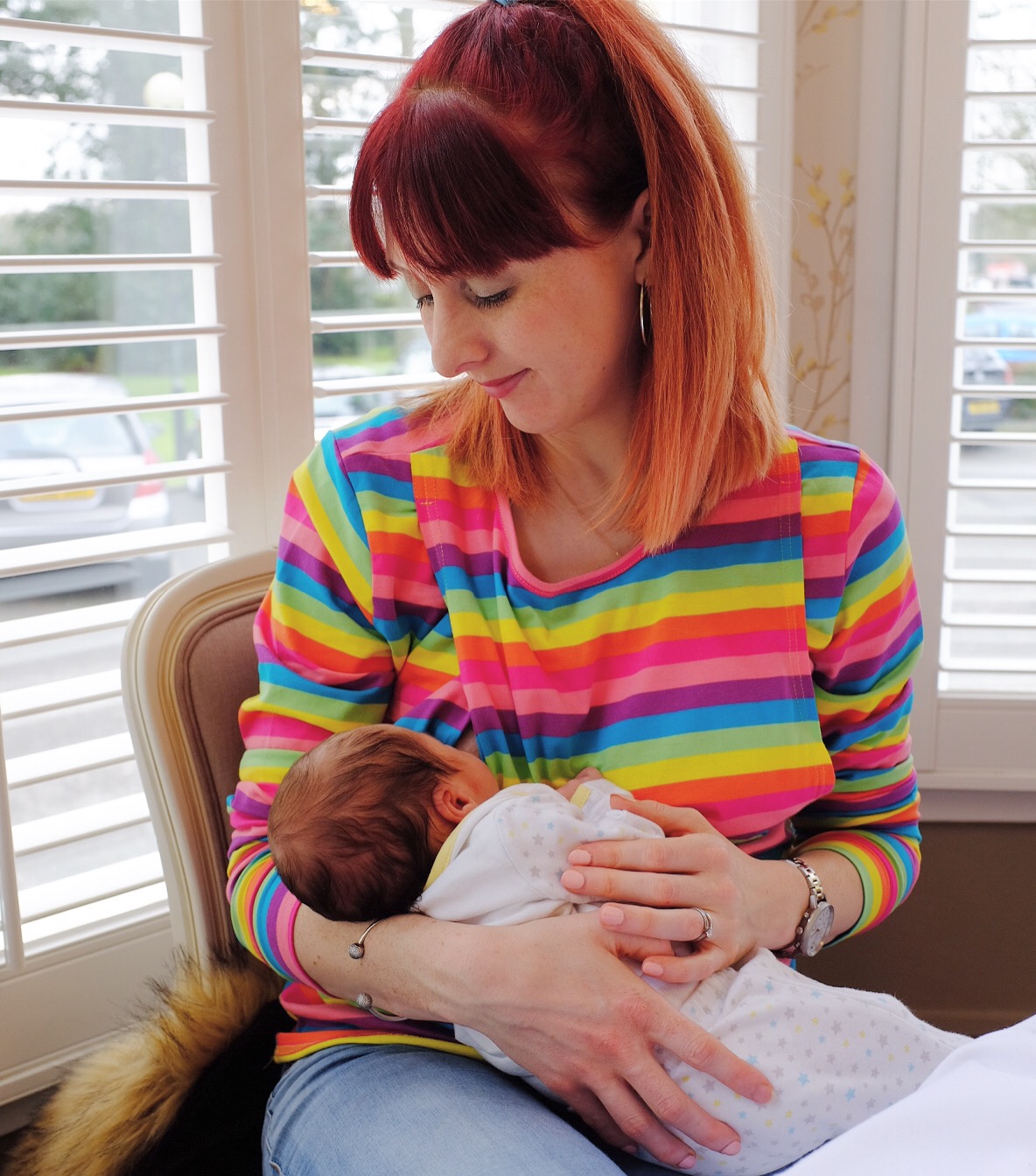 redhead breastfeeding her baby