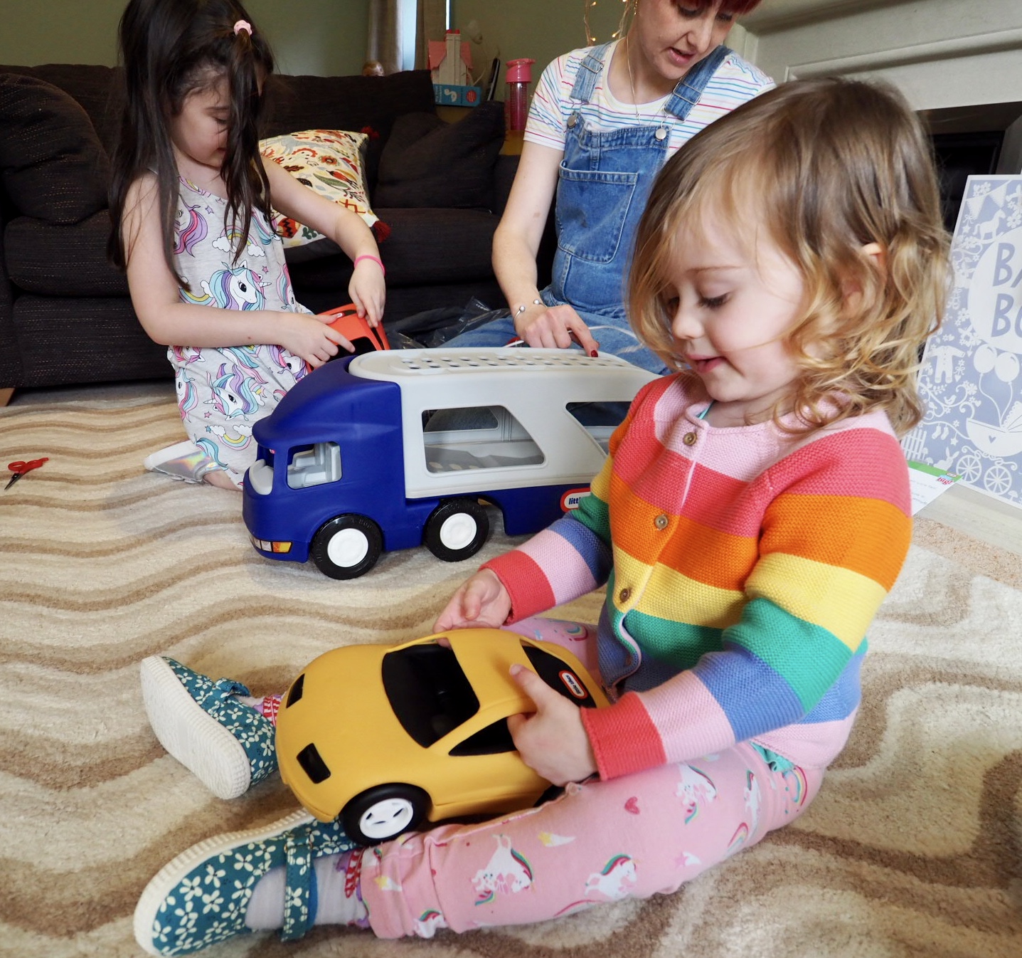 girl playing with the little tikes big car carrier