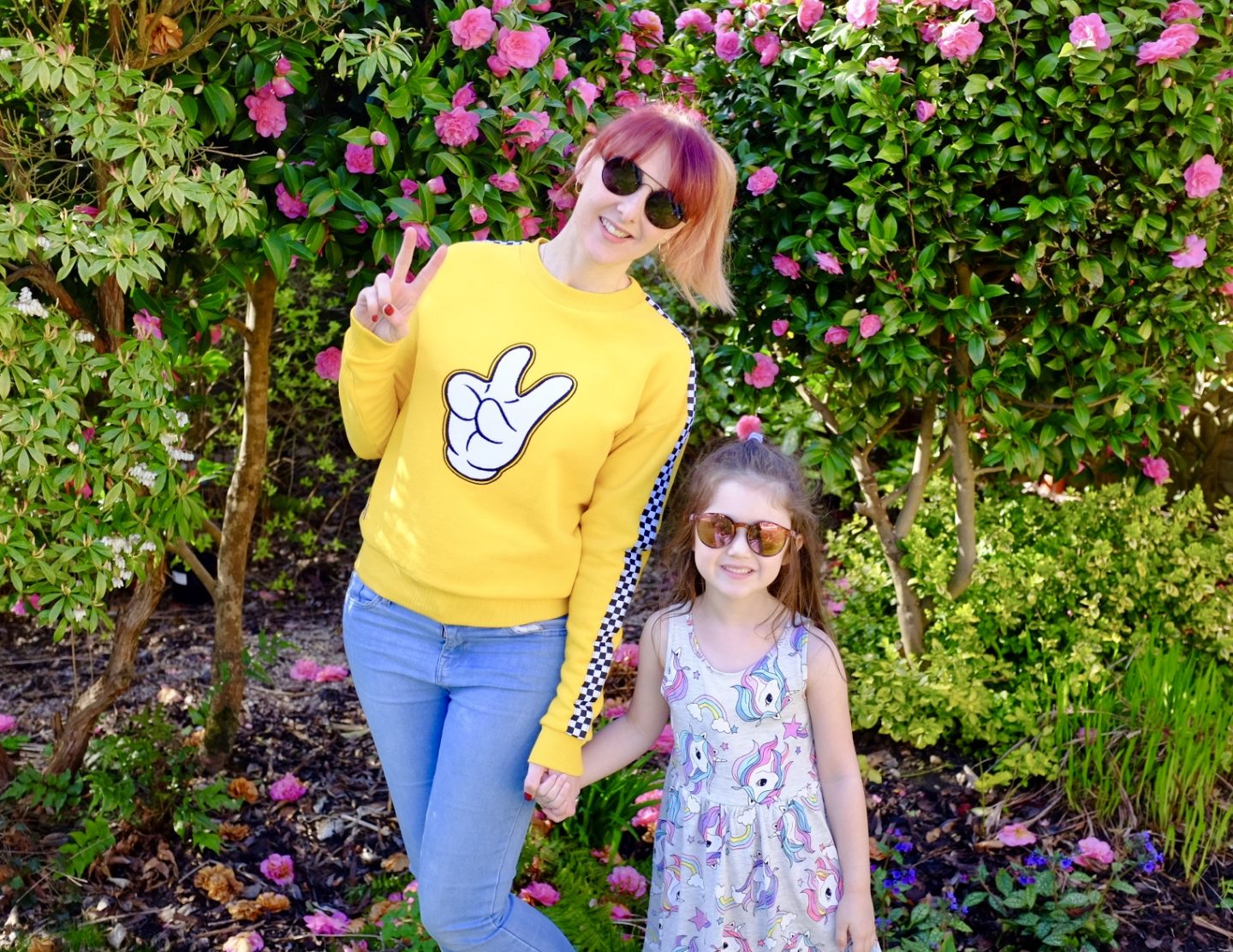 mum and daughter wearing a yellow Mickey shopDisney sweater