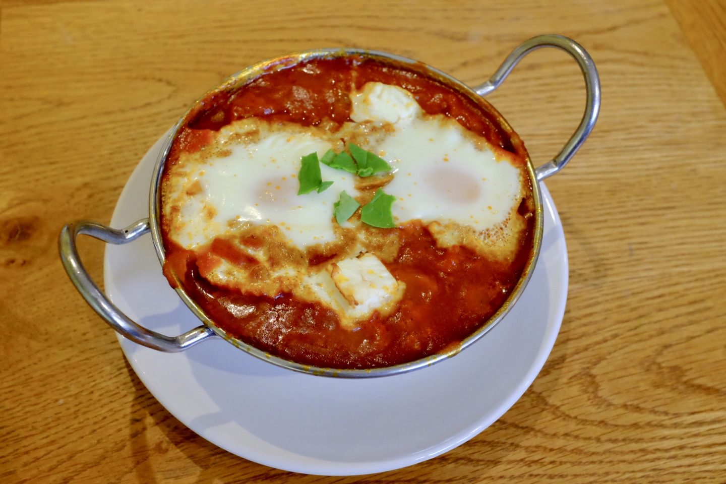 baked eggs served in a curry dish