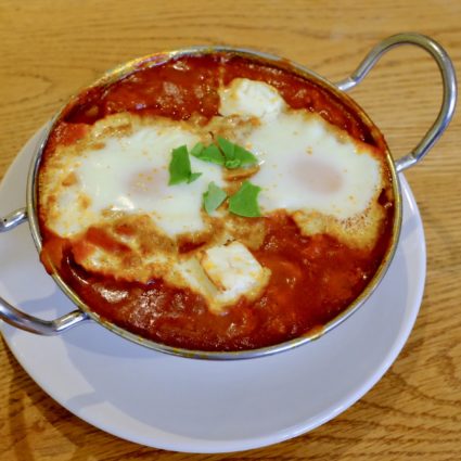 baked eggs served in a curry dish