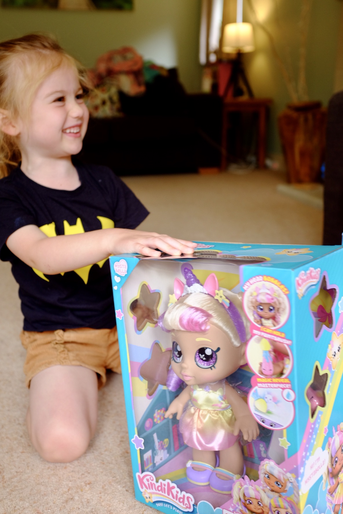 girl with mystabella Kindi Kids doll in a box
