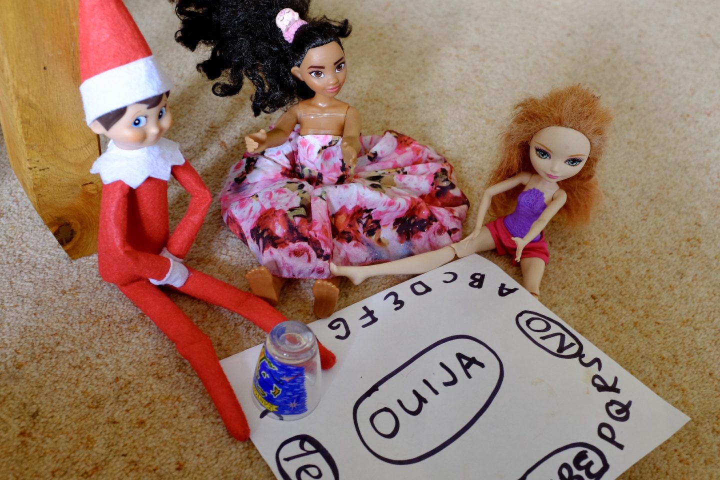 Elf does a ouija Board with the dolls. Naughty Elf on the shelf ideas