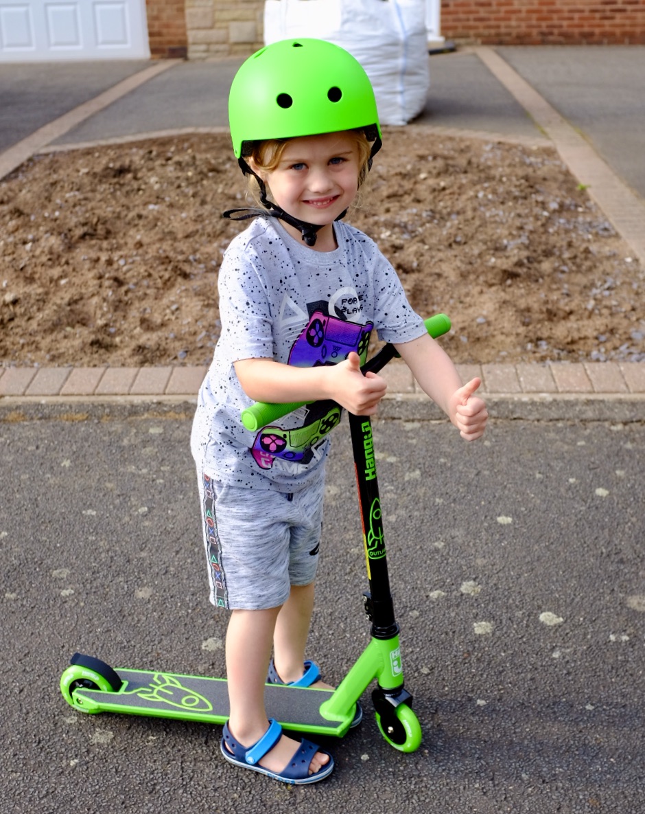 girl on the SFR kids scooter/skate helmet