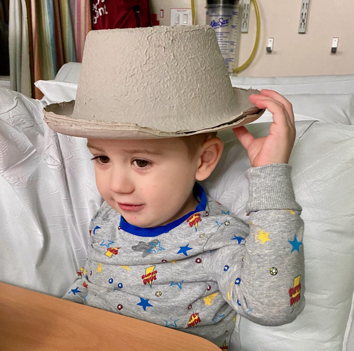 boy with sick bowl on his head 