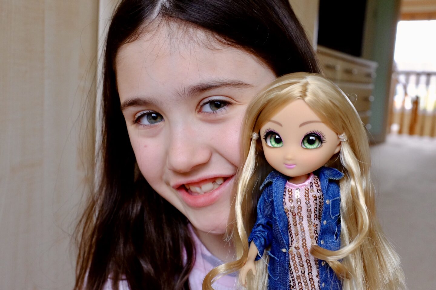 girl holding her unique eyes doll Amy